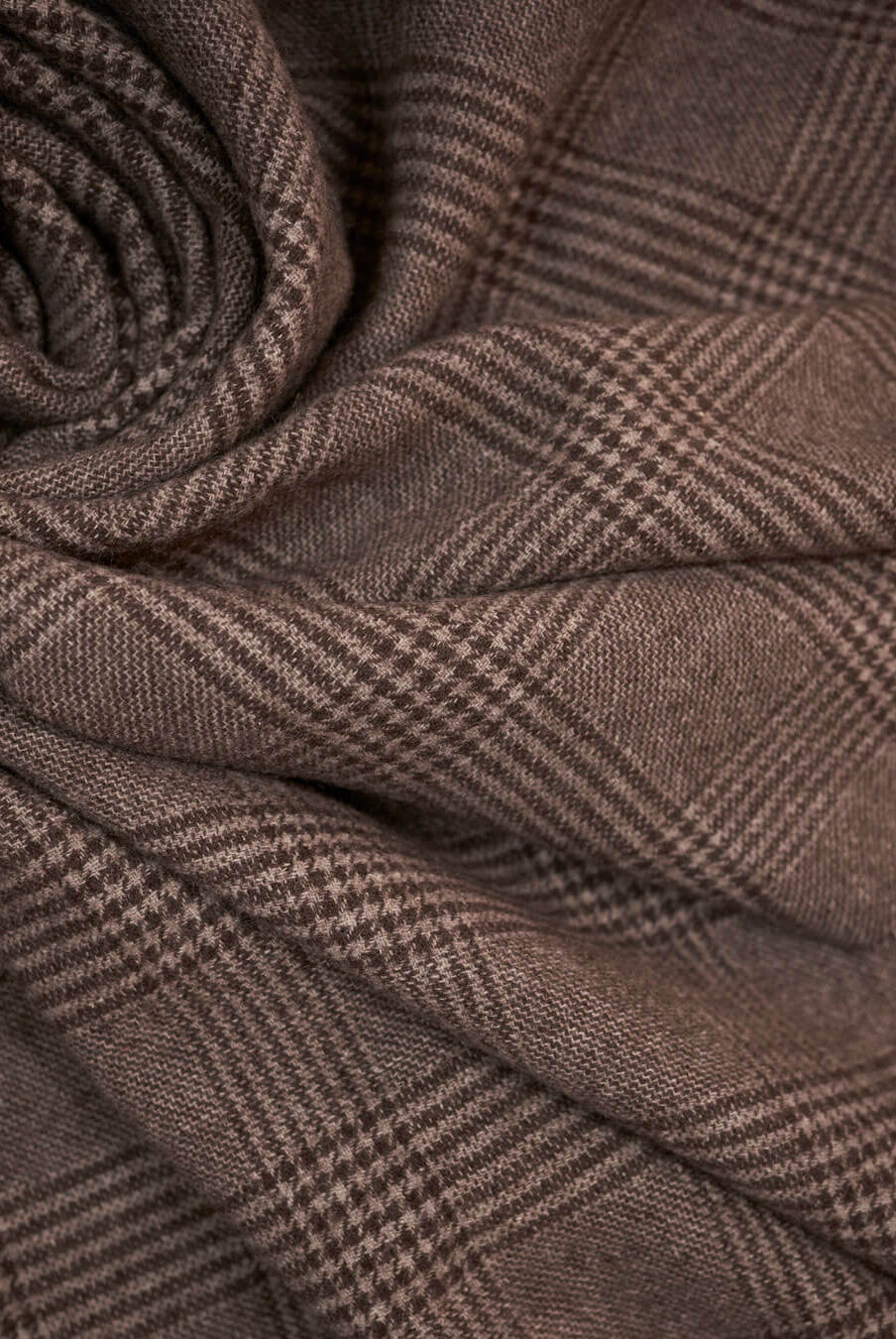 Detail image of yak wool plaid in brown check pattern, shown folded in soft layers