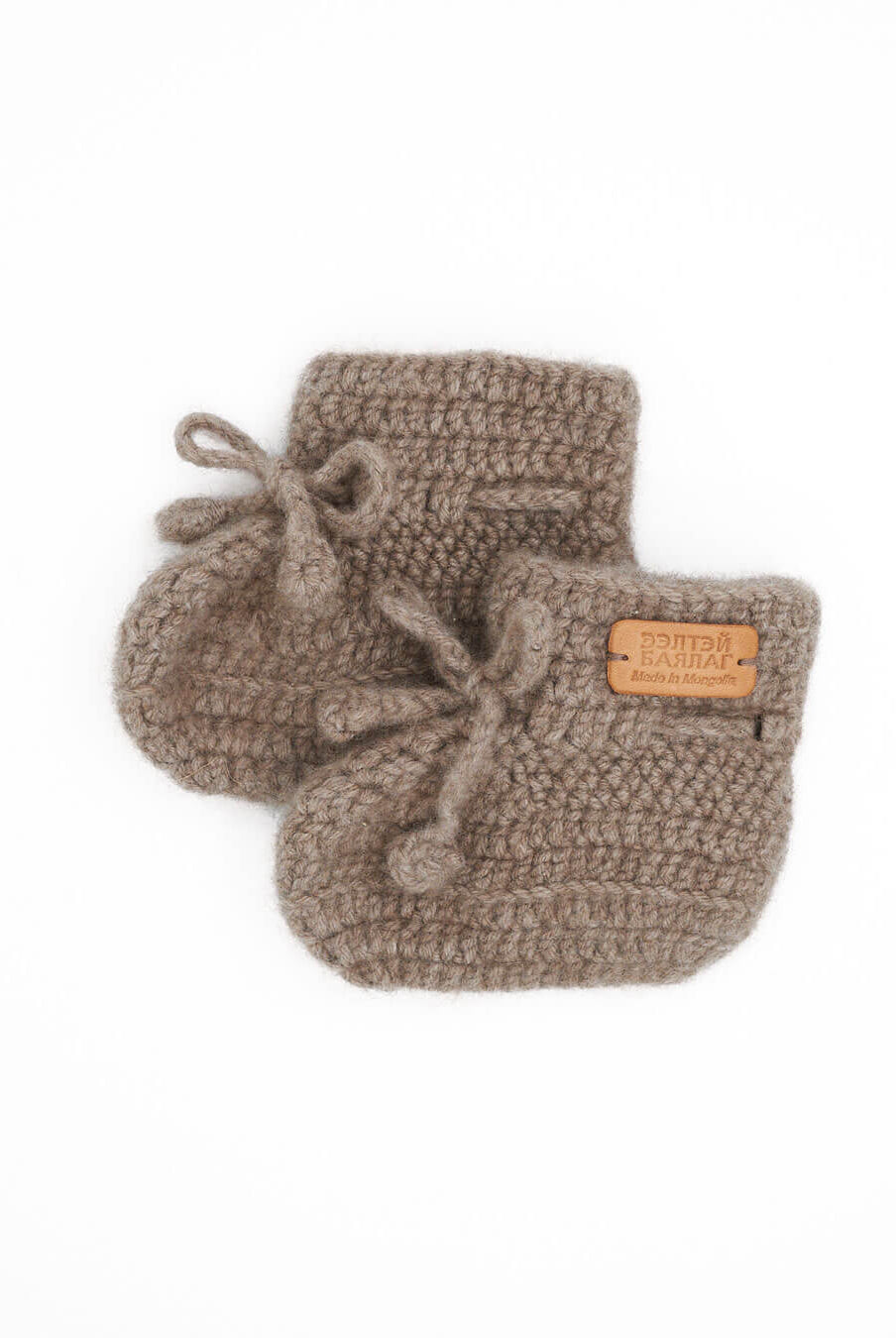 Saruul cashmere baby booties in Natural taupe on a white background.