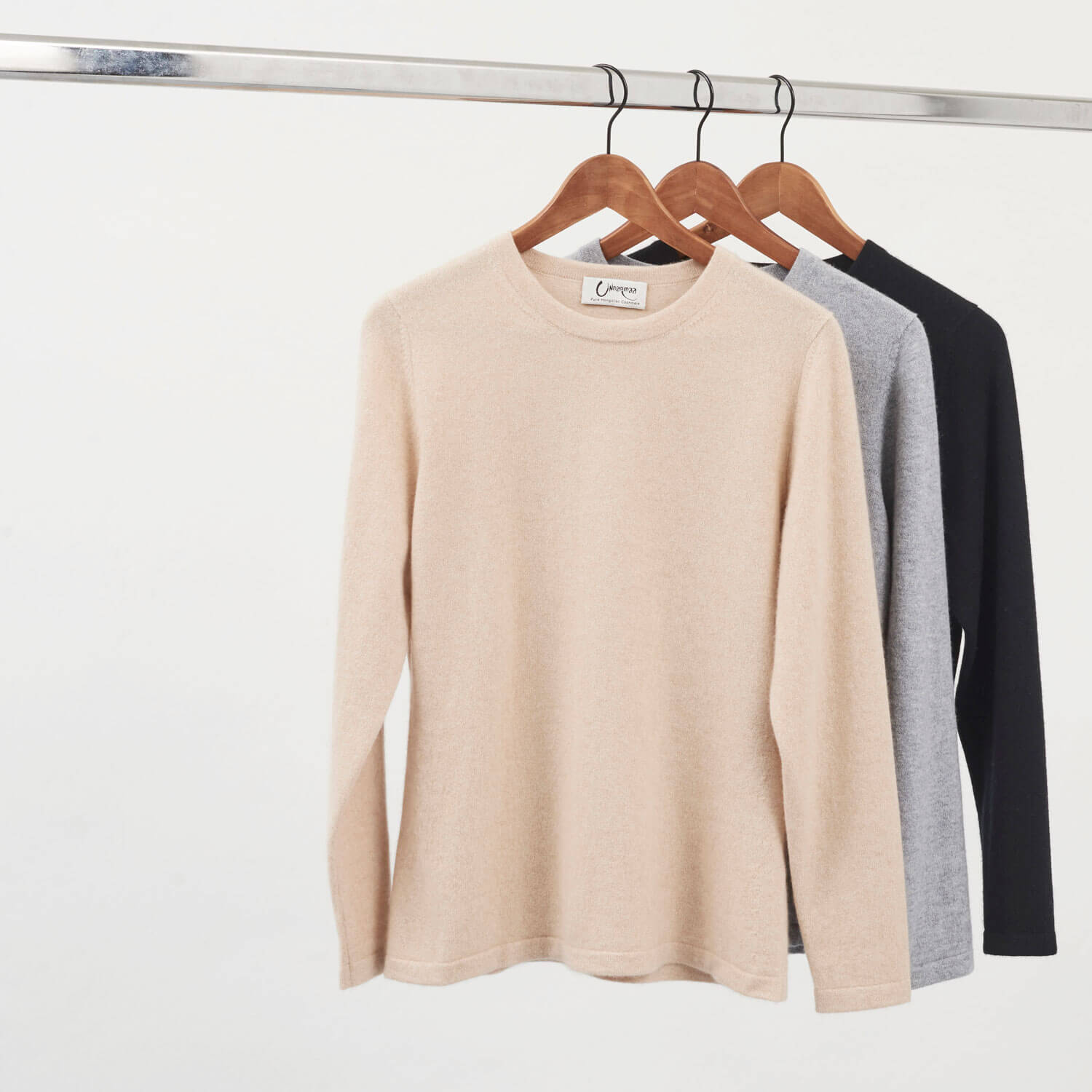 Undarmaa cashmere crewneck in three colors: light beige natural, light gray, and black