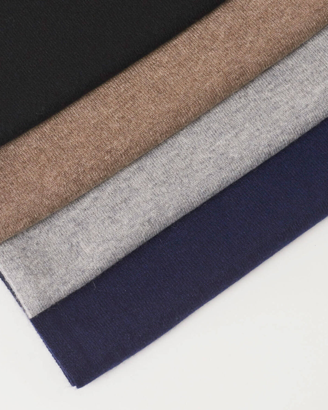 Undarmaa's lightweight cashmere scarves in dark gray-beige, light gray, black, and navy blue