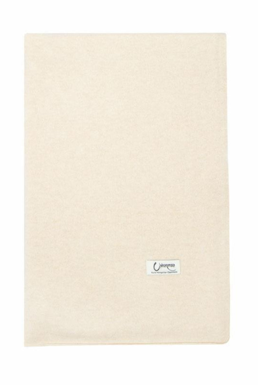 Det store naturfarvede cashmere tørklæde i lys beige ligger fladt.