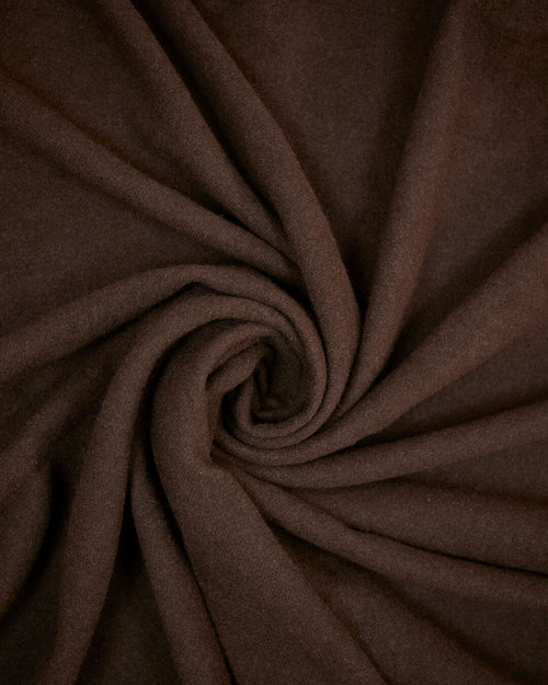 Nærbillede af den anden side af plaiden i mørk ensfarvet yakuld, blød og tæt vævet struktur.