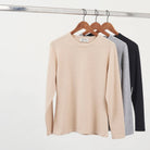 Undarmaa cashmere crewneck in three colors: light beige natural, light gray, and black
