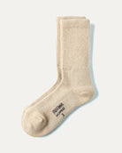 Dulaan sokker i cashmere, natural sand, på lys baggrund