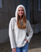 Kvinde iført Namuun hoodie i Natural white, hætte på.
