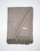 Vævet plaid i 100% yakuld, platinum grey, med frynser og Undarmaa-label.