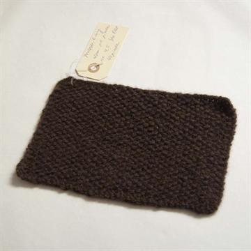 Et stykke stof strikket af mørk brun yakuld garn